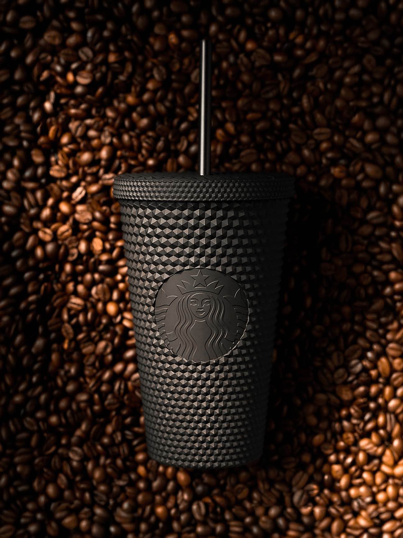 Matte black tumbler in coffee beans